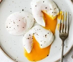 Perfectly poached eggs on toast with a sprinkle of herbs