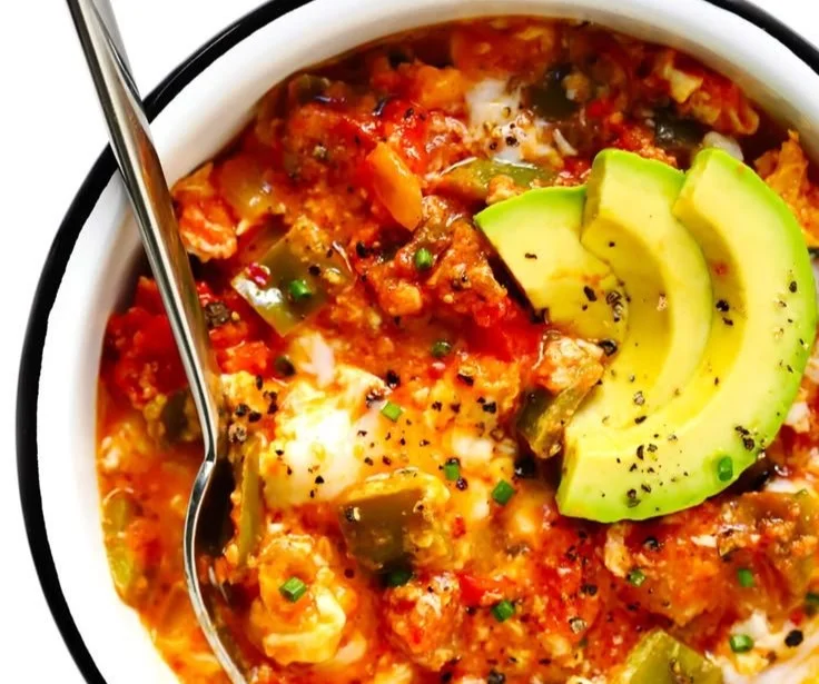 A colorful plate of Turkish Egg Scramble with tomatoes and spices.