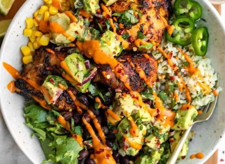 Delicious cilantro lime chicken bowls with fresh veggies and lime wedges