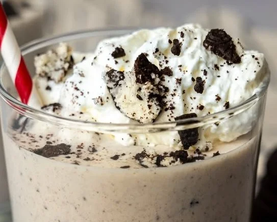 Delicious cookies and cream protein shake in a glass with a cookie on top