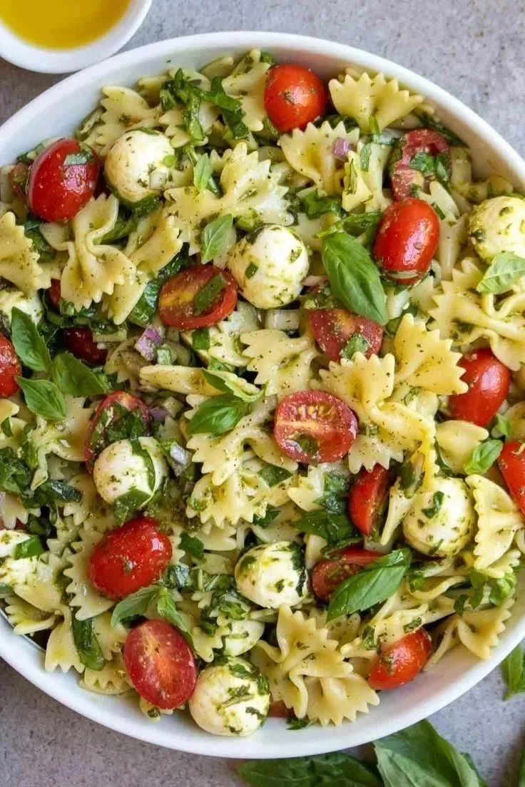 Colorful Italian Bow Tie Pasta Salad with fresh vegetables and dressing
